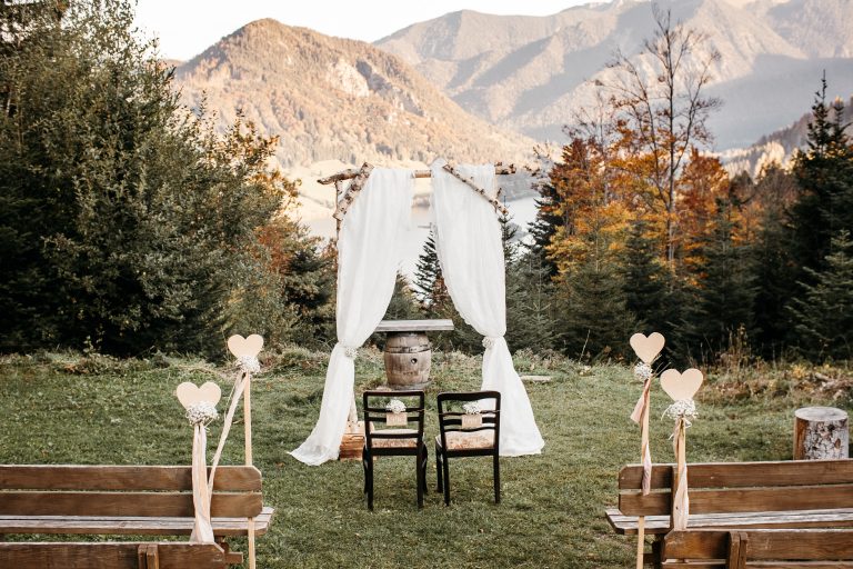 Traubogen mit Vorhang auf der Almwiese, Stühle für das Brautpaar, im Hintergrund Panoramablick auf Schliersee mit Berge